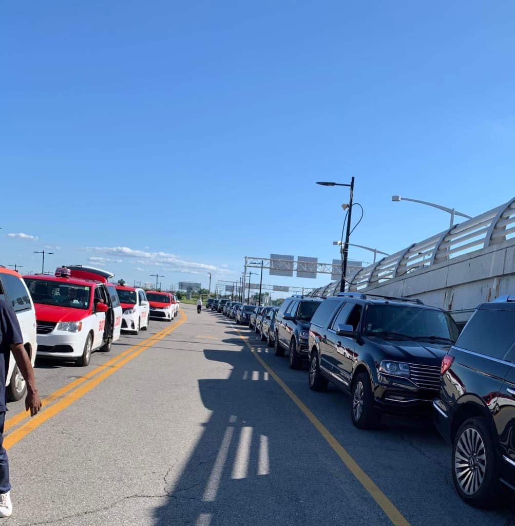 Luxury vs. Everyday—Transportation Choices for the 2025 Montreal Grand Prix Montreal Grand Prix 2025 transportation - A fleet of sleek limousines perfectly aligned along the wall, standing as the pinnacle of luxury. Parallel to them, a line of taxis with ample space in between, offering visitors the ultimate transportation choices for the 2025 Montreal Grand Prix.